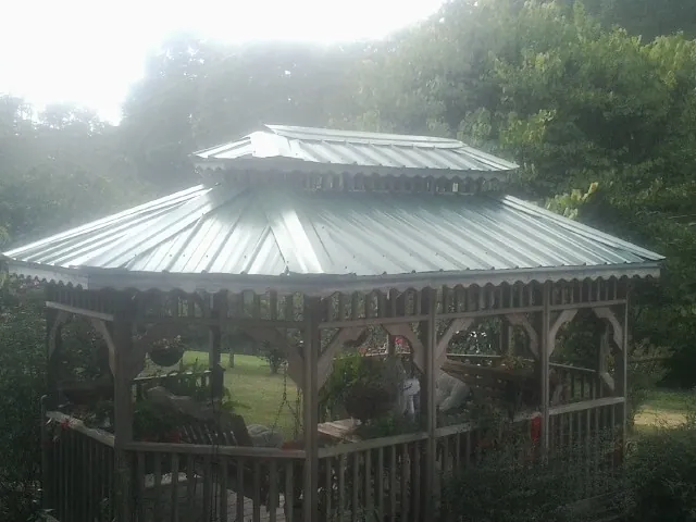 Two tier green metal roof on a garden gazebo in Orcas
