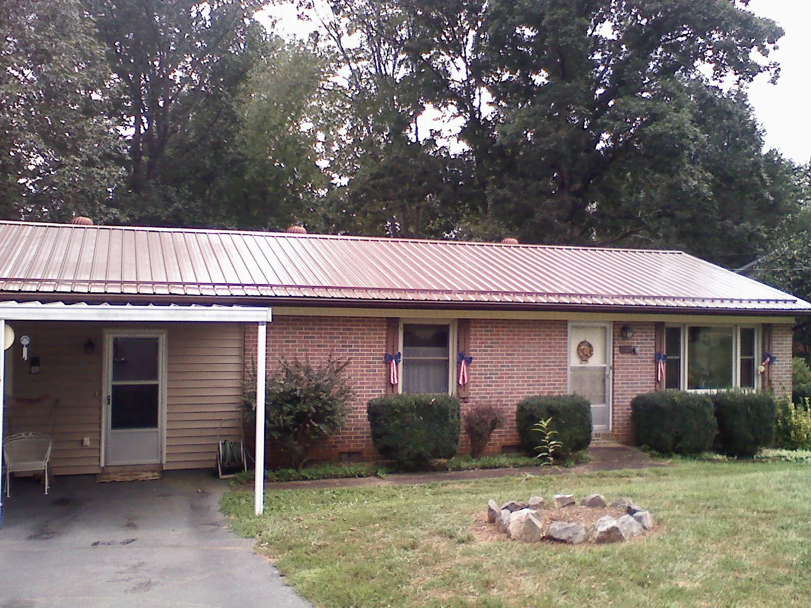 Bronze metal roof and carport on a brick ranch home — Roof Repair work by our crew in Orcas